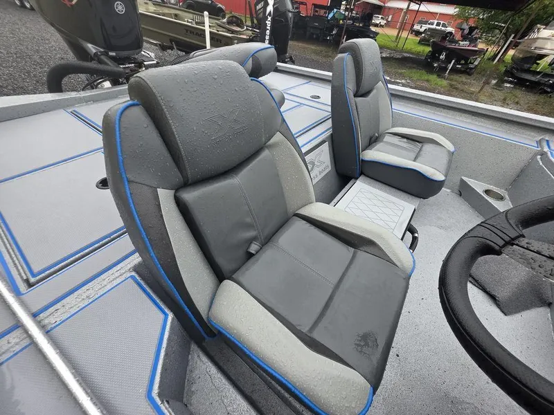 Slide: The Image of 2025 Xpress H20 Bass boat interior with gray and blue cushioned seats. - 11