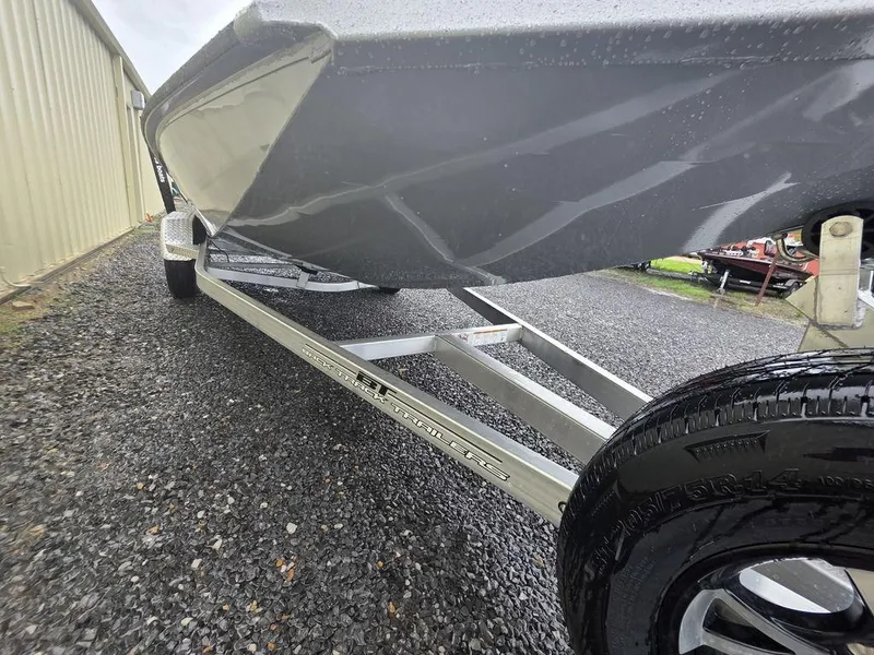 Slide: The Image of 2025 Xpress H20 Bass boat on trailer, close-up view of hull and wheels. - 14