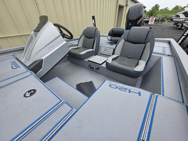 Slide: The Image of 2025 Xpress H20 Bass boat interior with dual seats and steering console. - 16