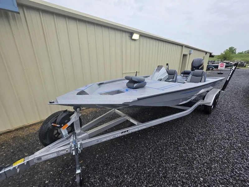 Slide: The Image of 2025 Xpress H20 Bass boat on trailer, parked outdoors near a building. - 3