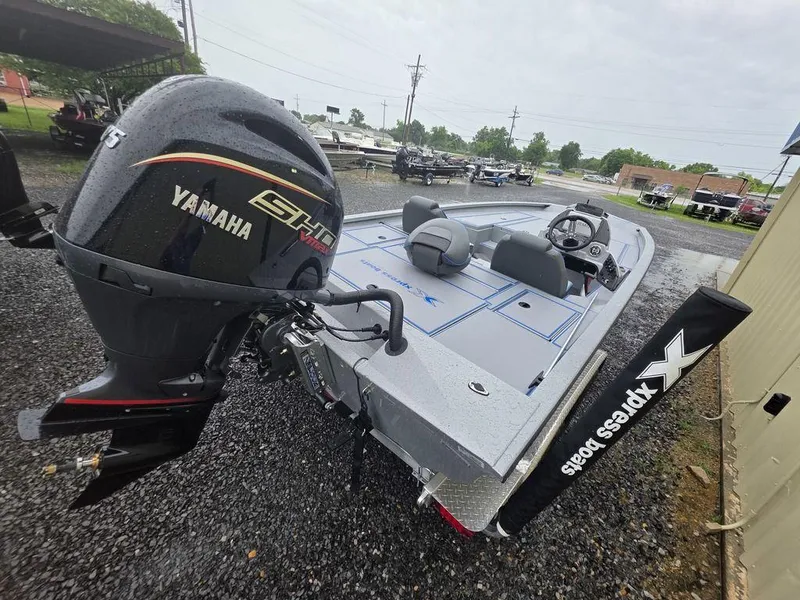 Slide: The Image of 2025 Xpress H20 Bass boat with Yamaha engine, parked on gravel. - 5
