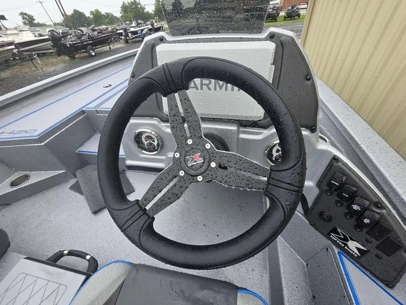 Slide: The Image of 2025 Xpress H20 Bass boat steering wheel and dashboard, featuring modern controls and design. - 8