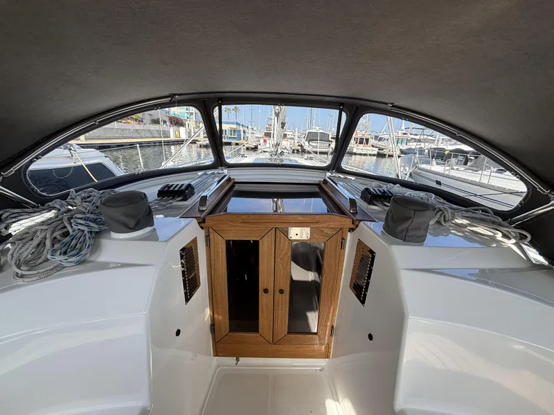 Slide: The Image of 2020 Bavaria Cruiser 34 yacht cockpit with ropes and wooden hatch, docked at marina. - 14