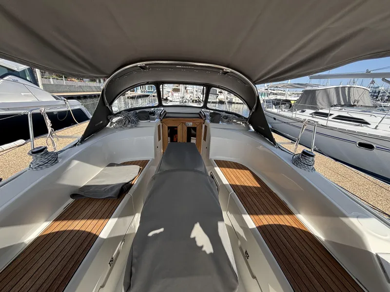 Slide: The Image of 2020 Bavaria Cruiser 34 yacht interior with sleek design and wooden deck in a marina setting. - 15