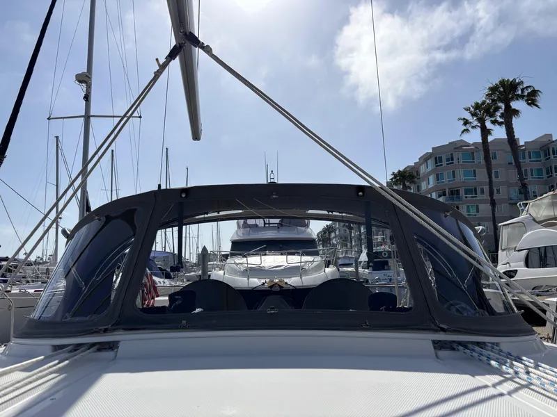 Slide: The Image of 2020 Bavaria Cruiser 34 sailboat docked in a sunny marina with palm trees. - 16