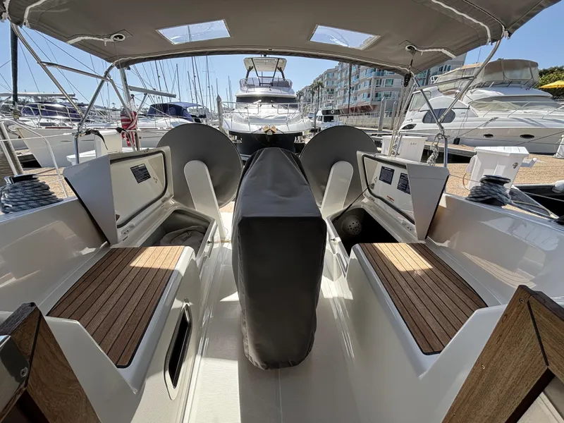 Slide: The Image of 2020 Bavaria Cruiser 34 yacht interior with seating and covered helm, docked at marina. - 17