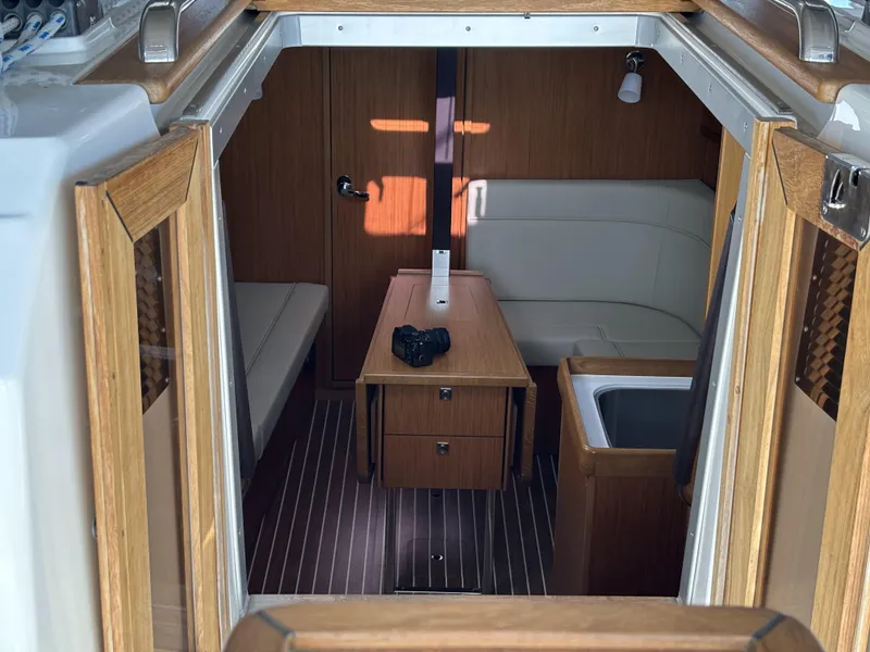 Slide: The Image of Interior of 2020 Bavaria Cruiser 34 yacht with wooden furnishings and seating area. - 20