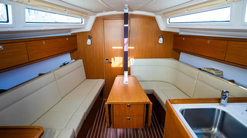 Slide: The Image of Interior of 2020 Bavaria Cruiser 34 yacht with wooden furnishings and beige seating. - 21