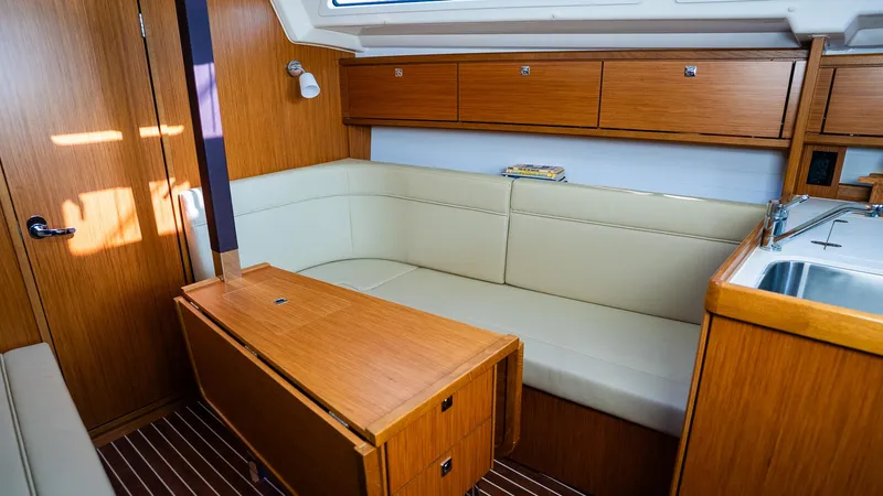 Slide: The Image of Interior of 2020 Bavaria Cruiser 34 yacht with wooden cabinetry and beige seating. - 23
