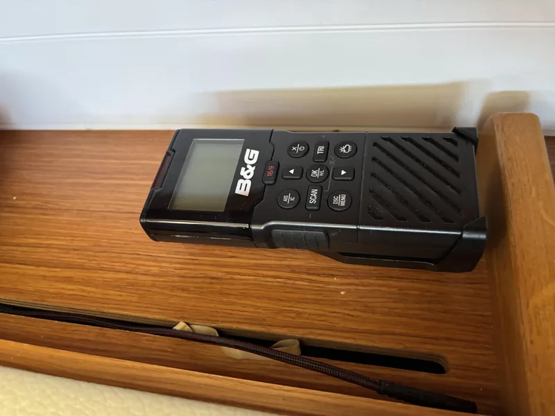 Slide: The Image of Handheld B&G marine radio on Bavaria Cruiser 34, 2020 model, wooden surface. - 27