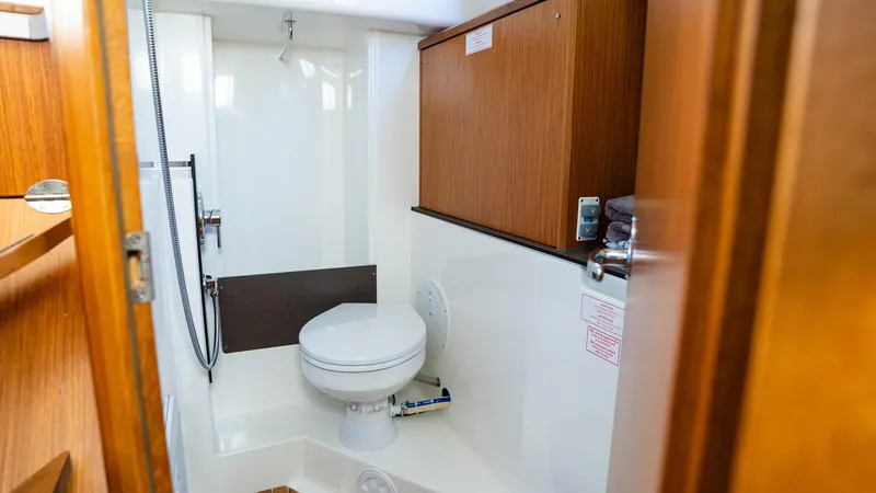 Slide: The Image of 2020 Bavaria Cruiser 34 yacht bathroom with wooden cabinets and modern fixtures. - 35