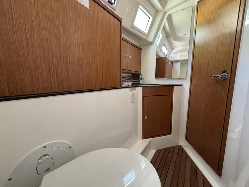 Slide: The Image of 2020 Bavaria Cruiser 34 yacht bathroom with wooden cabinets and flooring. - 37