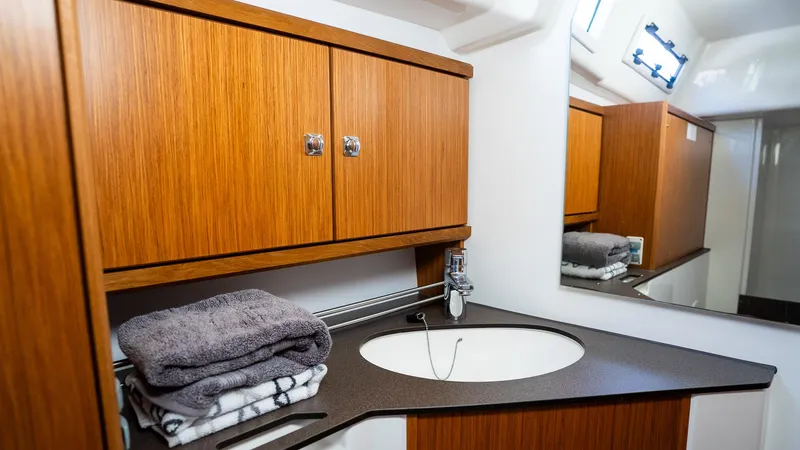 Slide: The Image of Modern bathroom in 2020 Bavaria Cruiser 34 yacht with wooden cabinets and sleek sink design. - 38
