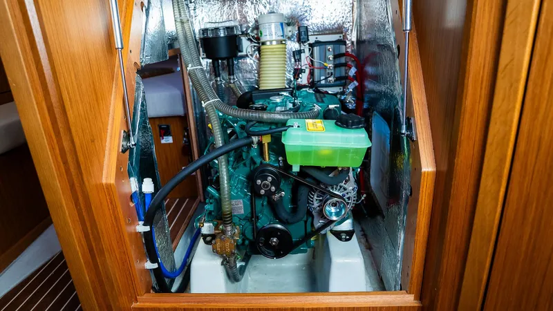 Slide: The Image of Engine compartment of a 2020 Bavaria Cruiser 34 sailboat, showcasing mechanical components. - 42
