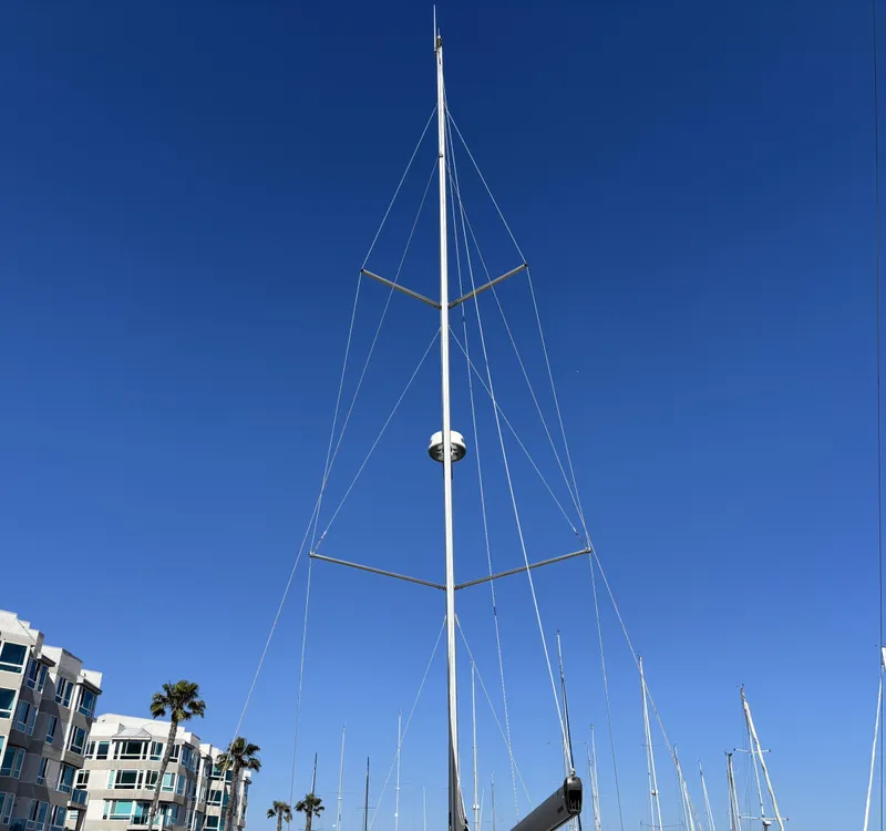 Slide: The Image of Tall mast of a 2020 Bavaria Cruiser 34 sailboat against a clear blue sky. - 5