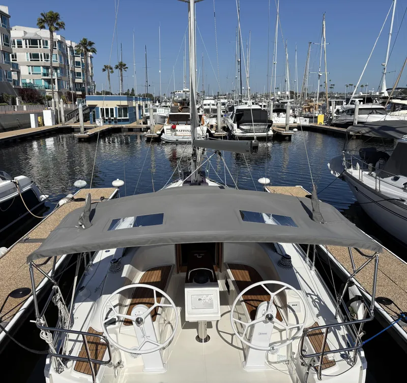 Slide: The Image of 2020 Bavaria Cruiser 34 yacht docked in a sunny marina, surrounded by sailboats. - 6