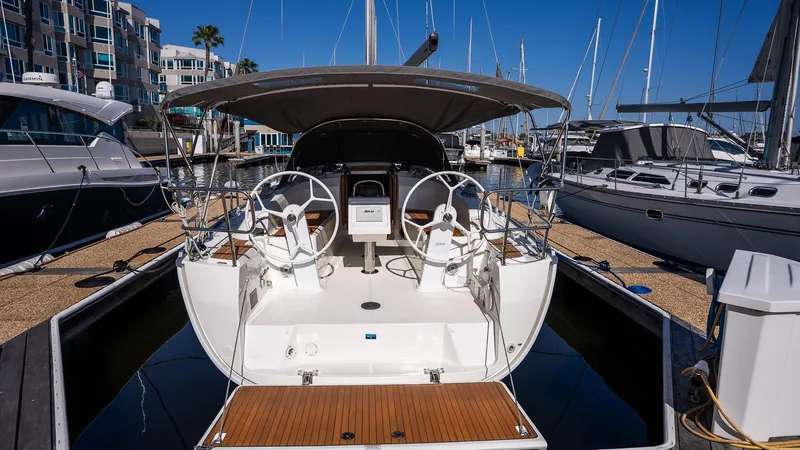 Slide: The Image of 2020 Bavaria Cruiser 34 yacht docked at marina, featuring dual steering wheels. - 8