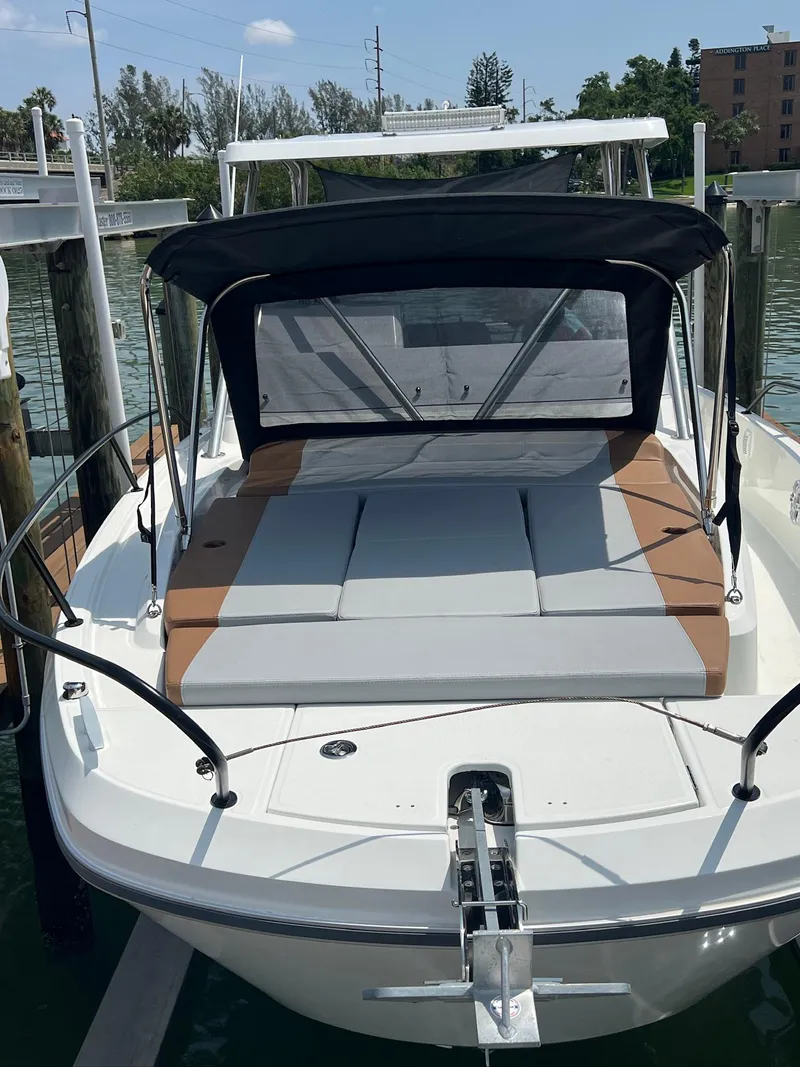 Slide: The Image of 2024 Beneteau 29' Flyer 9 SUNdeck boat docked, featuring a spacious sunbathing area. - 11
