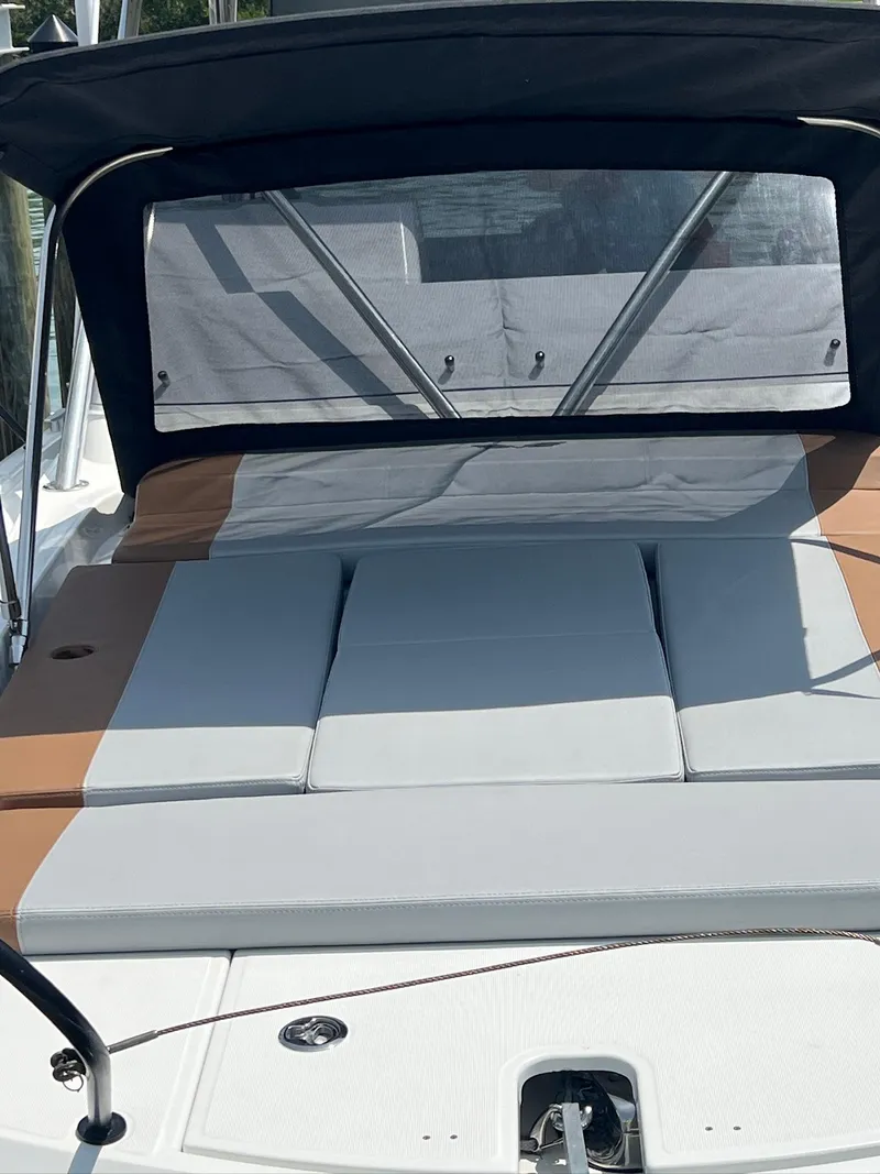 Slide: The Image of 2024 Beneteau 29' Flyer 9 SUNdeck with cushioned seating and canopy. - 22
