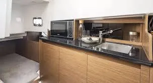 Slide: The Image of 2024 Beneteau 29' Flyer 9 SUNdeck interior kitchen with modern amenities and sleek design. - 23