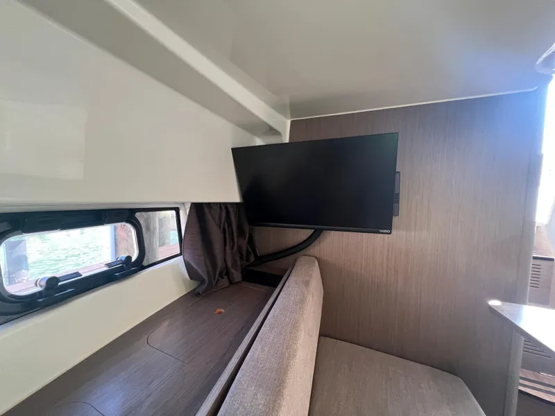 Slide: The Image of 2024 Beneteau 29' Flyer 9 SUNdeck interior with TV and seating area. - 24