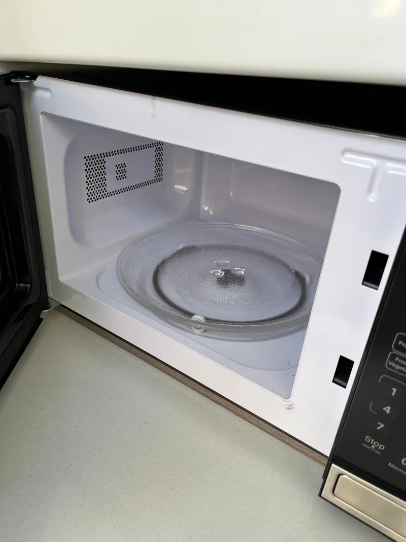 Slide: The Image of Open microwave oven with a clean interior and glass turntable. - 29