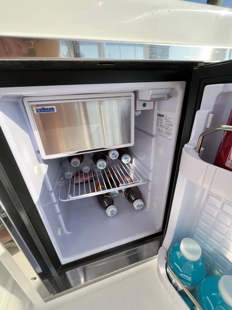 Slide: The Image of 2024 Beneteau Flyer 9 SUNdeck mini fridge stocked with beverages. - 30