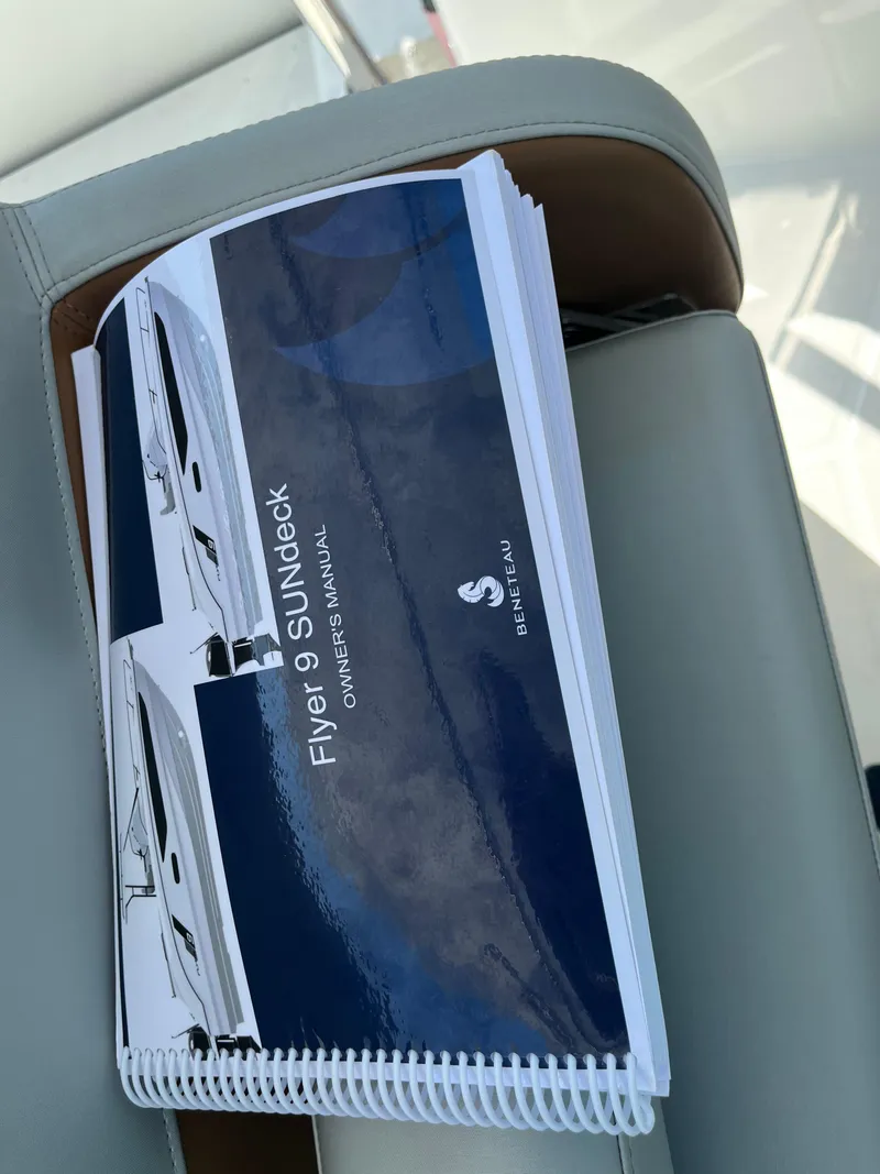 Slide: The Image of 2024 Beneteau Flyer 9 SUNdeck owner's manual on boat seat. - 32