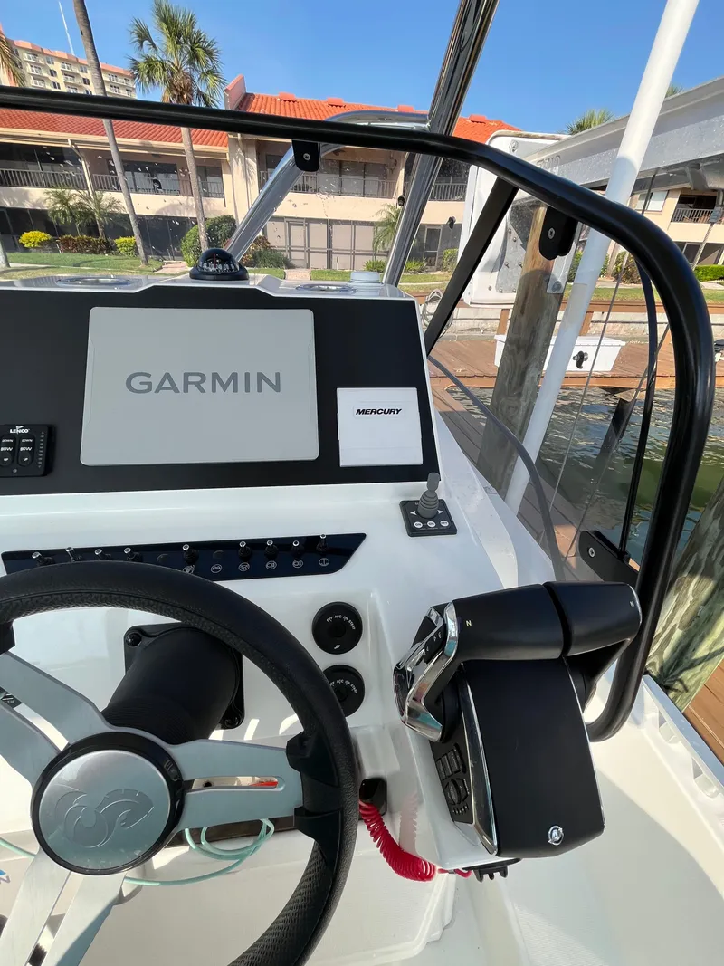 Slide: The Image of 2024 Beneteau Flyer 9 SUNdeck helm with Garmin navigation system, docked in a marina. - 5