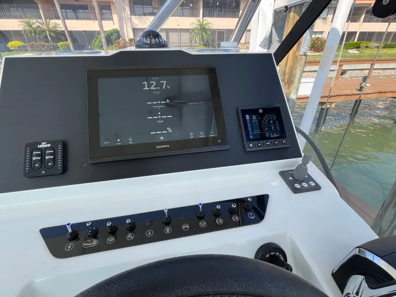 Slide: The Image of Helm of 2024 Beneteau 29' Flyer 9 SUNdeck with modern navigation controls. - 8