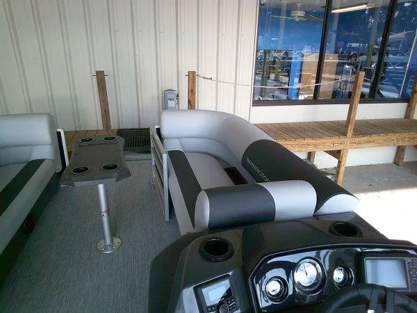 Slide: The Image of 2025 Bennington 22SSR pontoon boat interior with seating and control panel. - 2