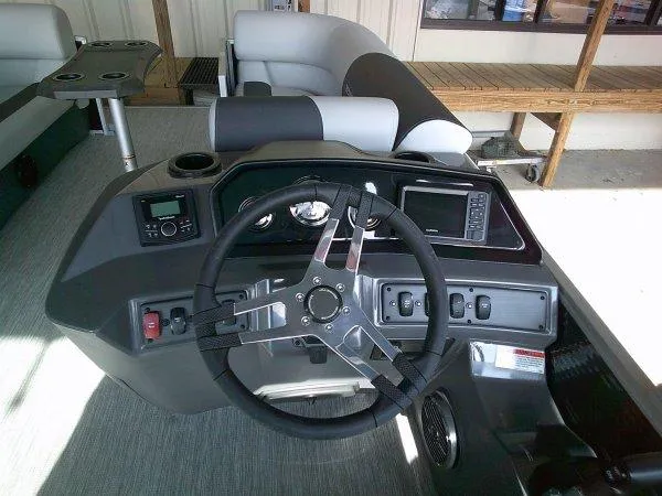 Slide: The Image of 2025 Bennington 22SSR boat dashboard with steering wheel and control panel. - 8