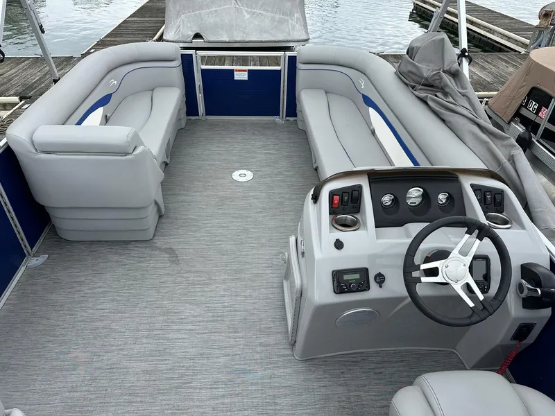 Slide: The Image of 2022 Bennington 24 SSR Quad Bench pontoon boat interior with Yamaha 25Hp engine, docked. - 10