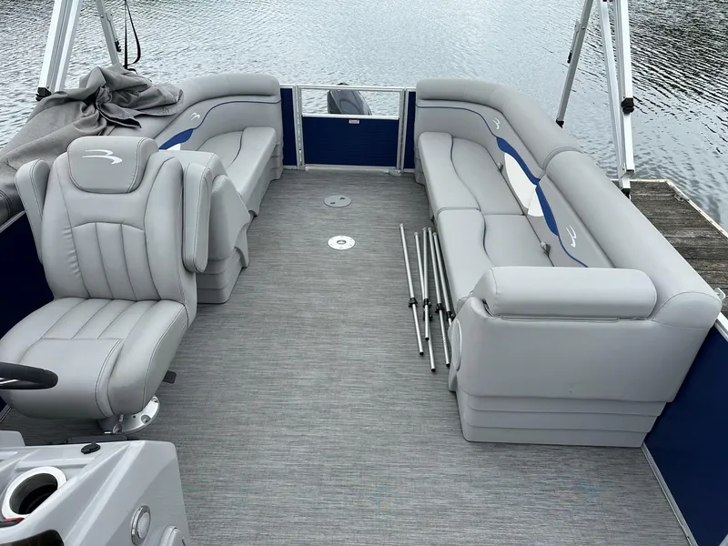 Slide: The Image of 2022 Bennington 24 SSR Quad Bench pontoon boat interior with gray seating and Yamaha 25Hp engine. - 11