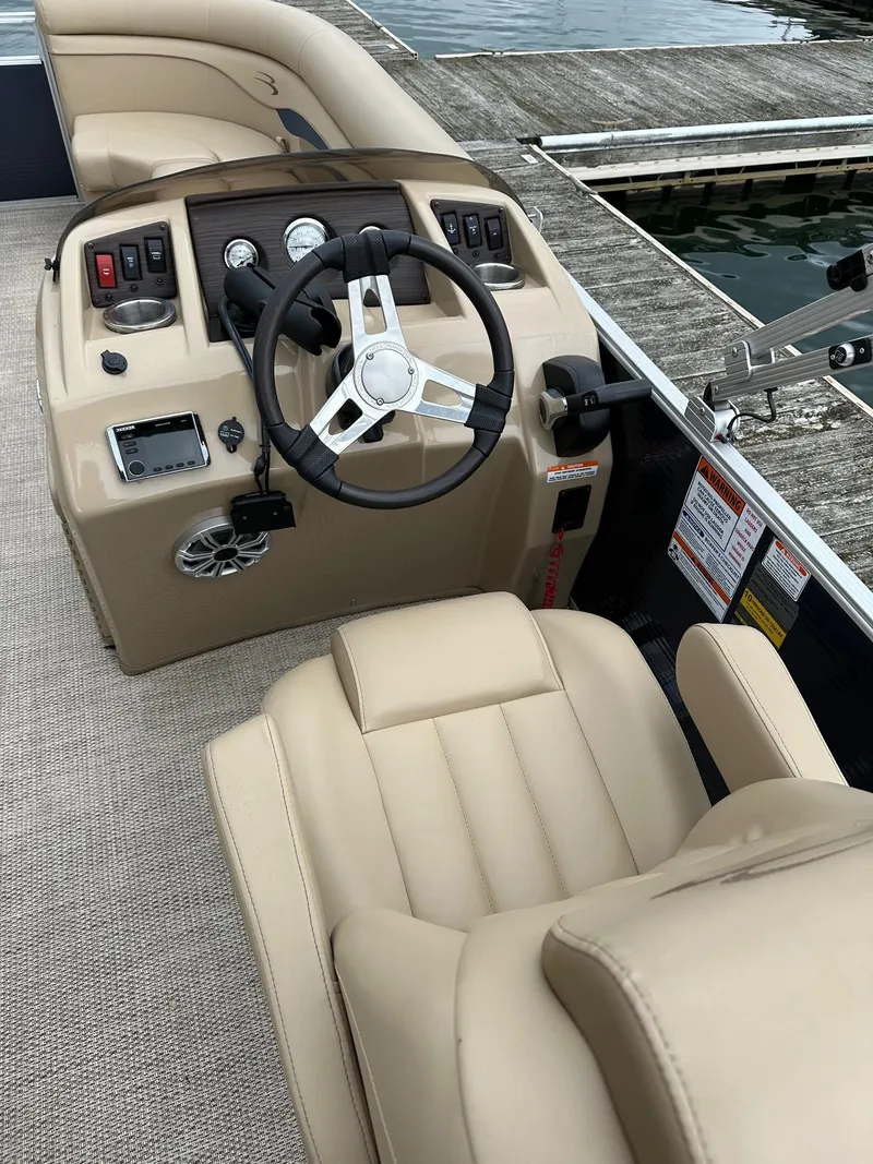 Slide: The Image of 2018 Bennington 20 SSN Family/Fish Pontoon interior with steering wheel and controls. - 8