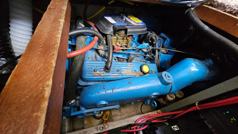 Slide: The Image of 1990 Carver 32 Aft Cabin engine compartment with blue engine components and wiring. - 29