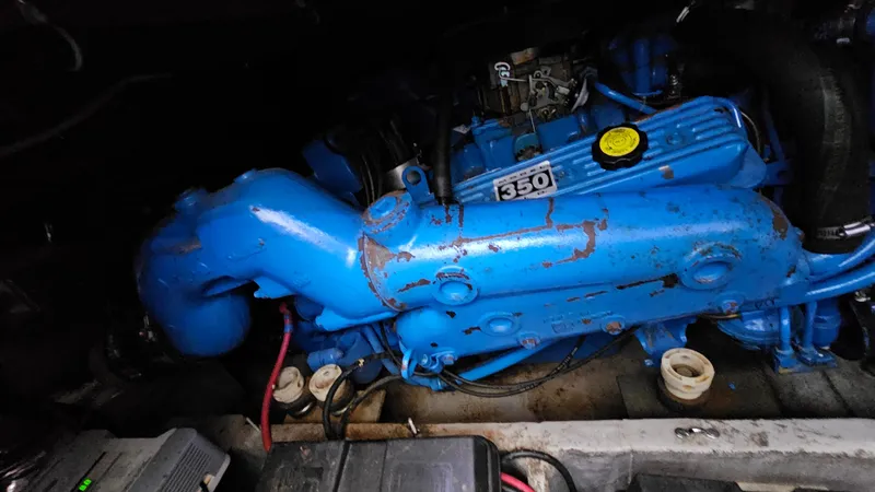 Slide: The Image of Engine of a 1990 Carver 32 Aft Cabin boat, featuring a blue 350 model. - 31