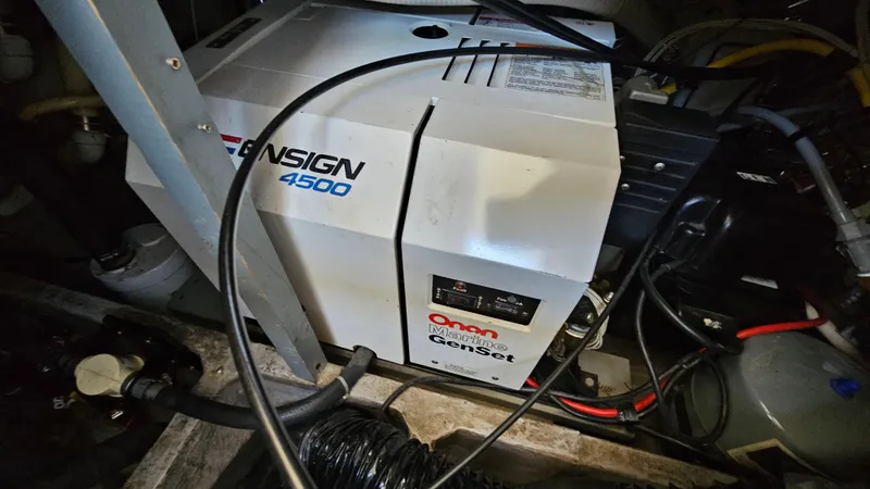 Slide: The Image of Generator in 1990 Carver 32 Aft Cabin boat engine room, featuring Onan Ensign 4500 model. - 32