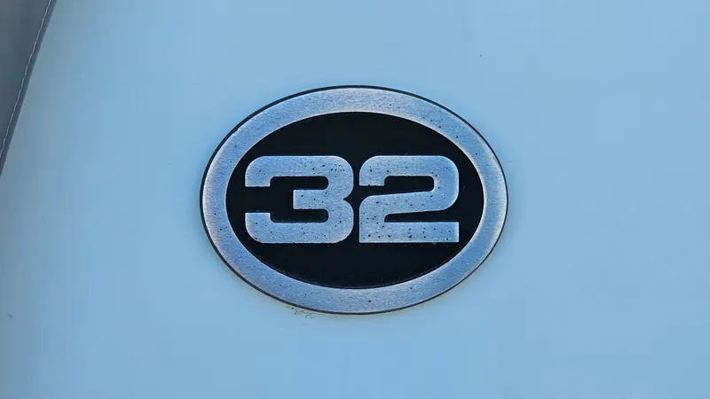 Slide: The Image of 1990 Carver 32 Aft Cabin emblem on a light blue background. - 35