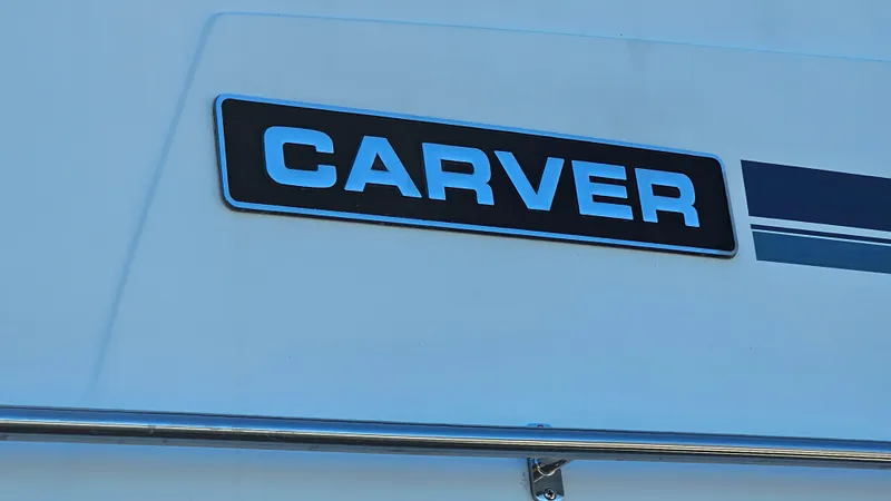 Slide: The Image of Carver 32 Aft Cabin 1990 boat logo on white surface. - 36