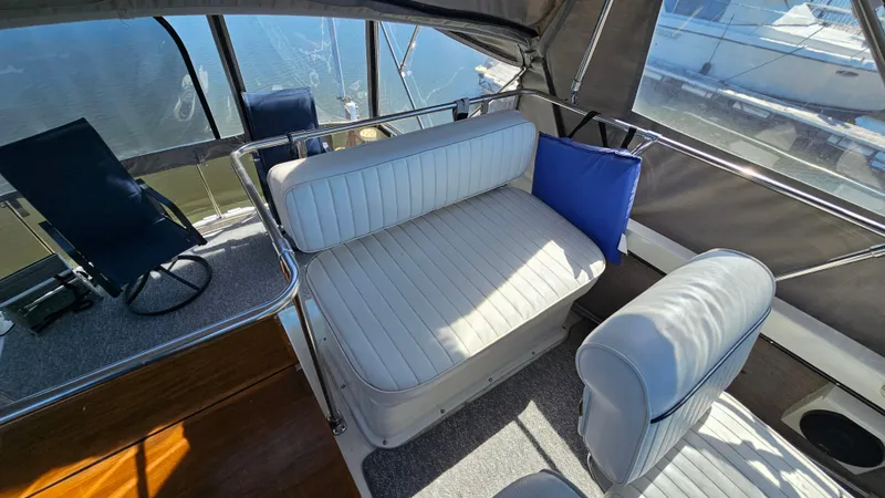 Slide: The Image of 1990 Carver 32 Aft Cabin interior with white seating and blue accents. - 9