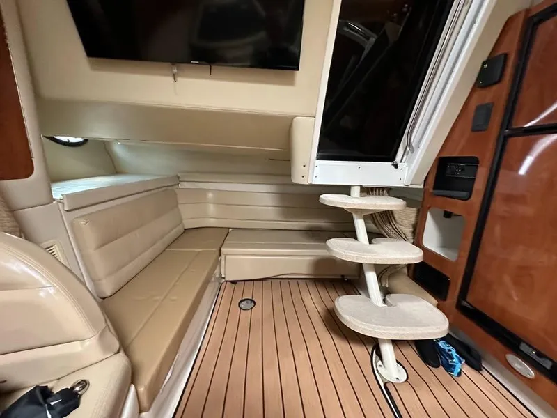 Slide: The Image of Interior of 2003 Wellcraft 3700 Martinique boat with beige seating and wooden flooring. - 7