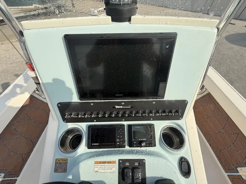 Slide: The Image of Control panel of a 2021 Pathfinder 2400 TRS boat with electronic displays and switches. - 10