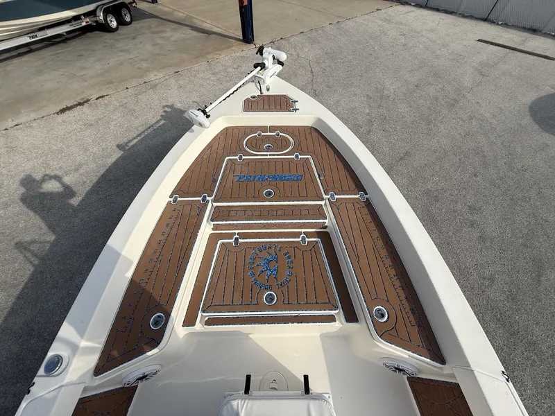 Slide: The Image of 2021 Pathfinder 2400 TRS boat deck with custom wood finish and logo detailing. - 11