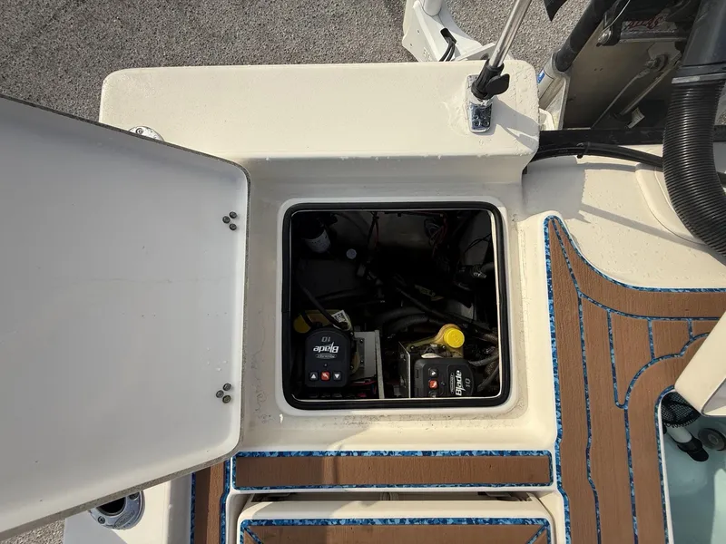 Slide: The Image of Open hatch of 2021 Pathfinder 2400 TRS boat showing internal components and wiring. - 15