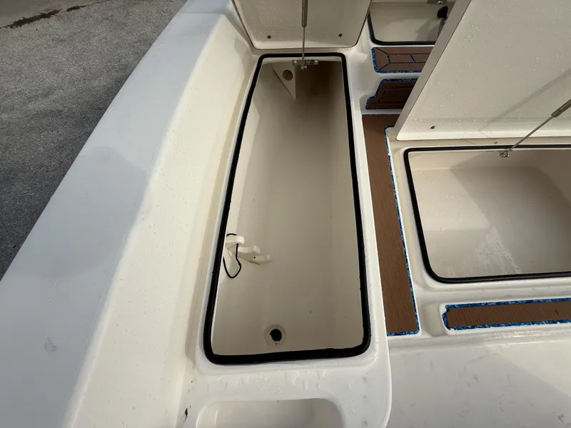 Slide: The Image of 2021 Pathfinder 2400 TRS boat storage compartments, open and empty, with clean interior. - 19