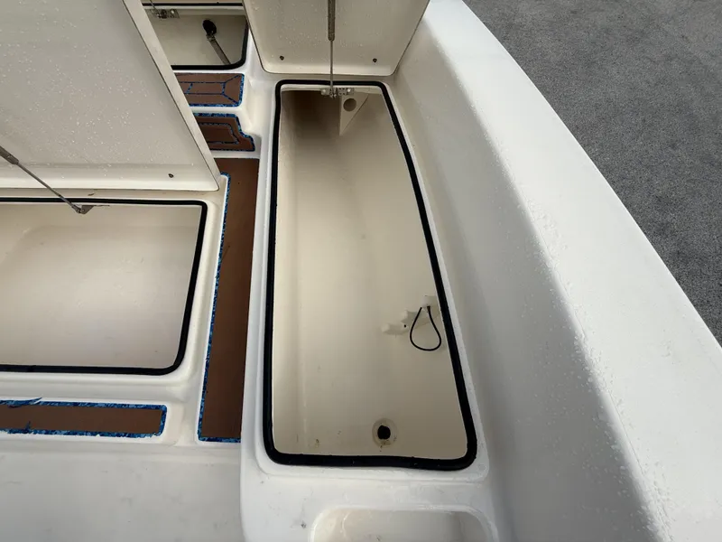 Slide: The Image of Open storage compartment on a 2021 Pathfinder 2400 TRS boat, showing interior details. - 20