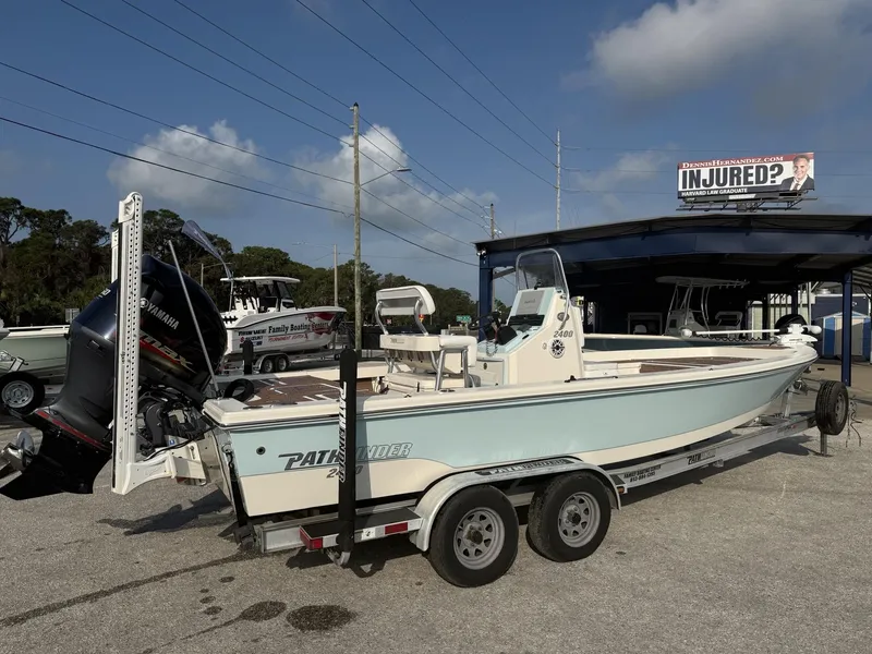 Slide: The Image of 2021 Pathfinder 2400 TRS boat on trailer with Yamaha engine, parked outdoors. - 25