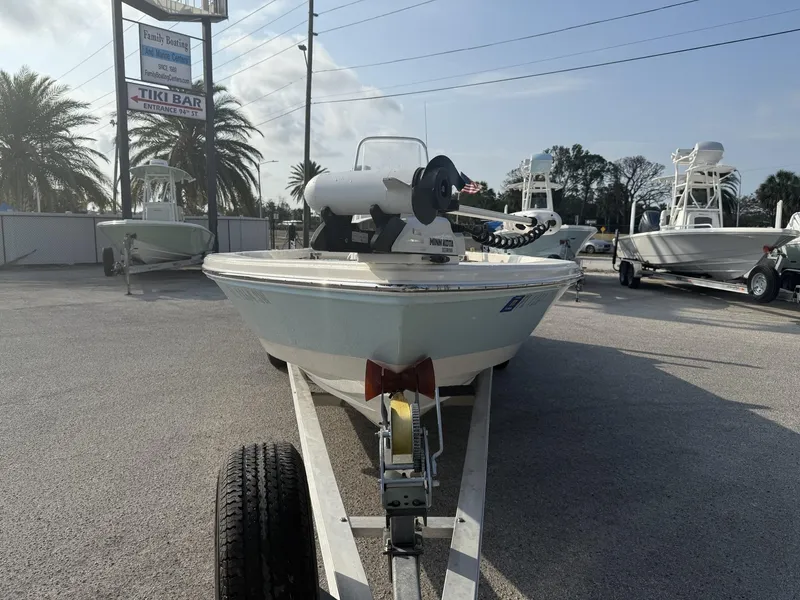 Slide: The Image of 2021 Pathfinder 2400 TRS boat on trailer at a marina with palm trees. - 26