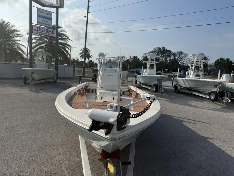 Slide: The Image of 2021 Pathfinder 2400 TRS boat displayed at a dealership with palm trees in the background. - 27